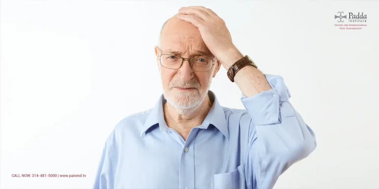 Older man in glasses holding his head with a puzzled expression