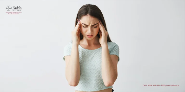 Woman pressing both temples with a headache