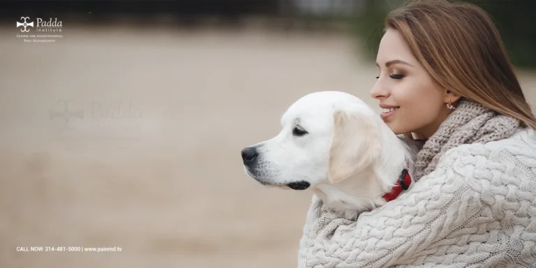 Woman resting her head against a white dog
