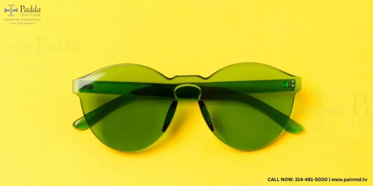 Pair of green tinted sunglasses on a yellow background