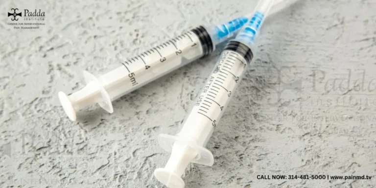 Two syringes resting on a pale textured surface
