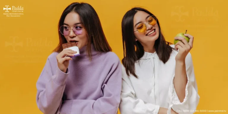 Two young women eating fruit against a yellow background