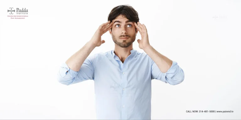 Man pressing his fingers to his temples with a headache