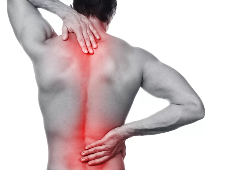 Bare back of a man with the upper back highlighted in red