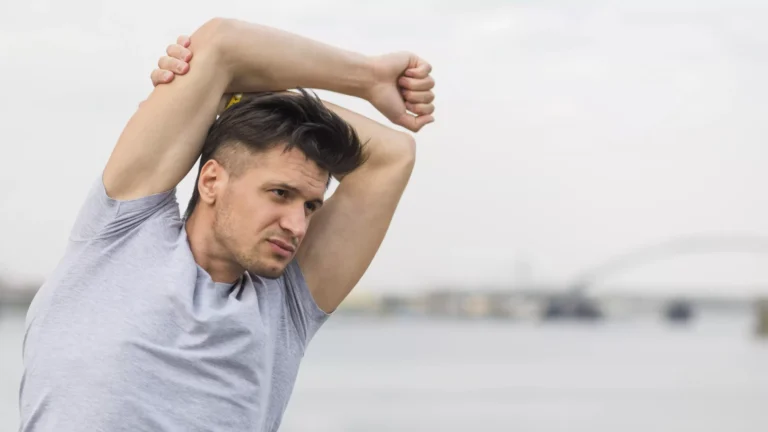 Man stretching both arms above his head