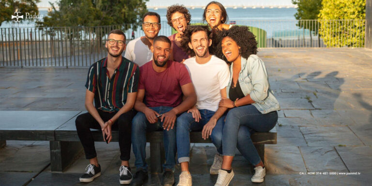 Group of friends sitting together on a bench outdoors