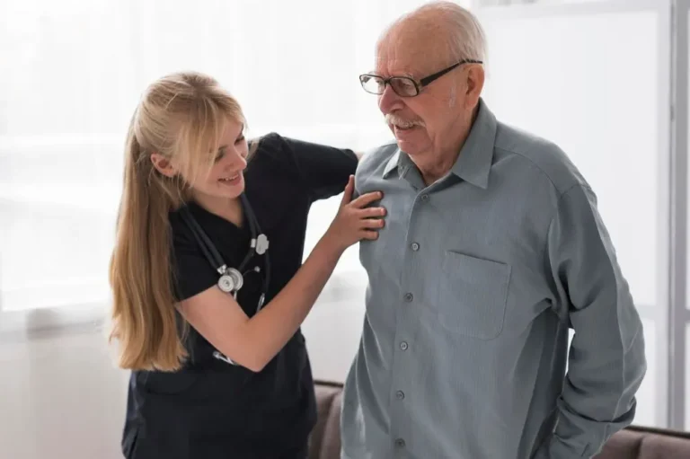 Woman helping an older man with shoulder discomfort