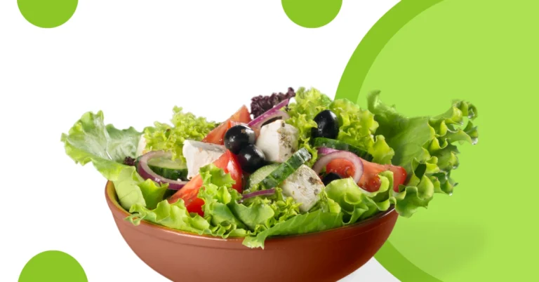 Bowl of mixed salad on a green background
