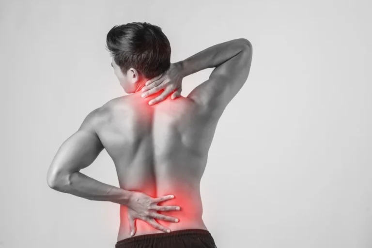 Back view of a man with the neck and spine highlighted in red