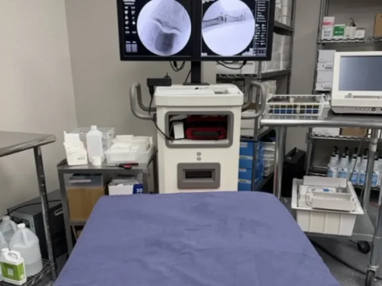 Fluoroscopy procedure room with live imaging monitors at Padda Institute, St. Louis