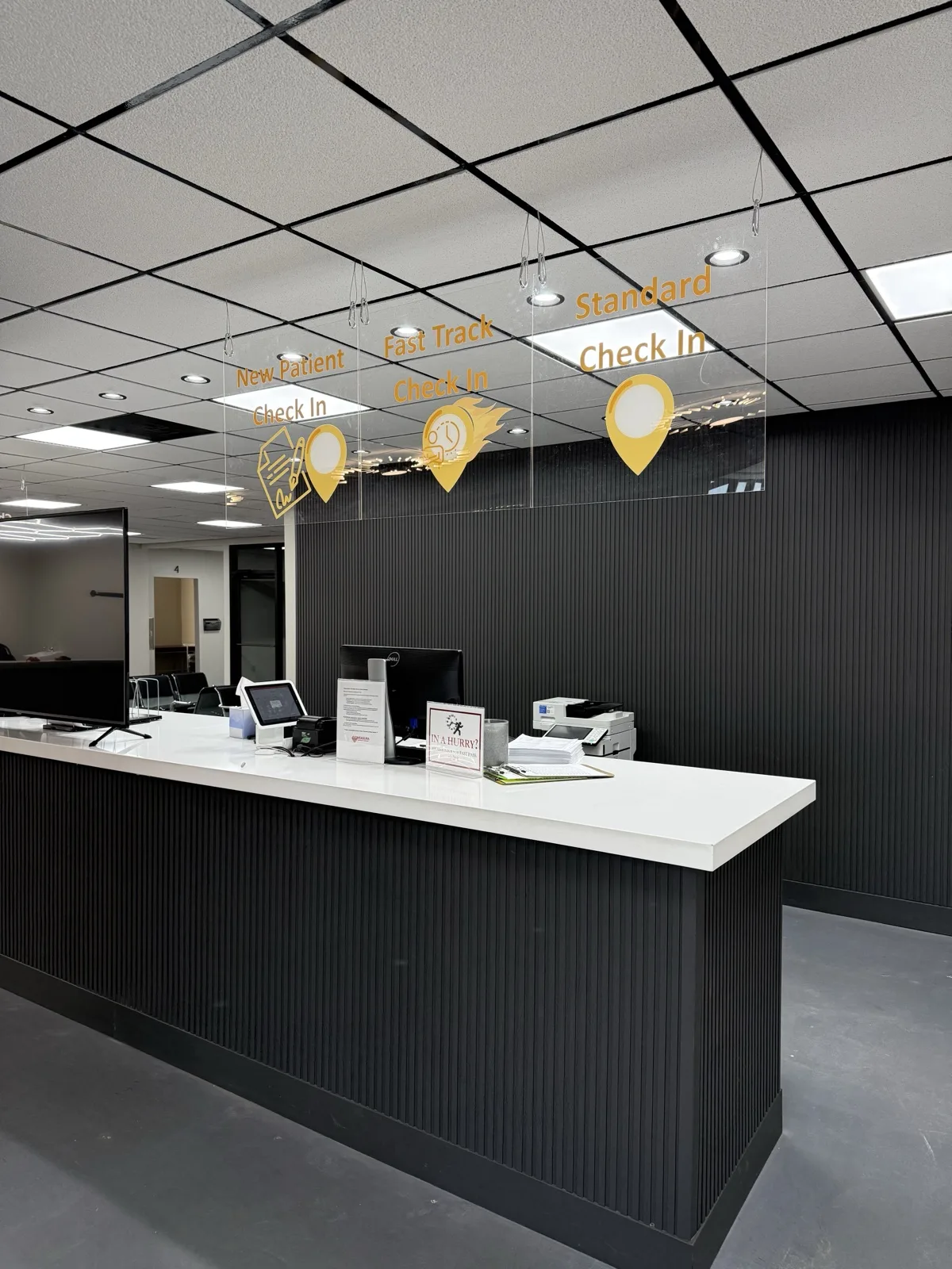Patient check-in desk with New Patient, Fast Track and Standard Check In lanes at the Padda Institute Woodson Road facility