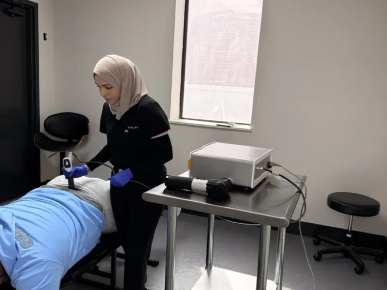Clinician delivering shockwave therapy to a patient in a treatment room at Padda Institute, St. Louis