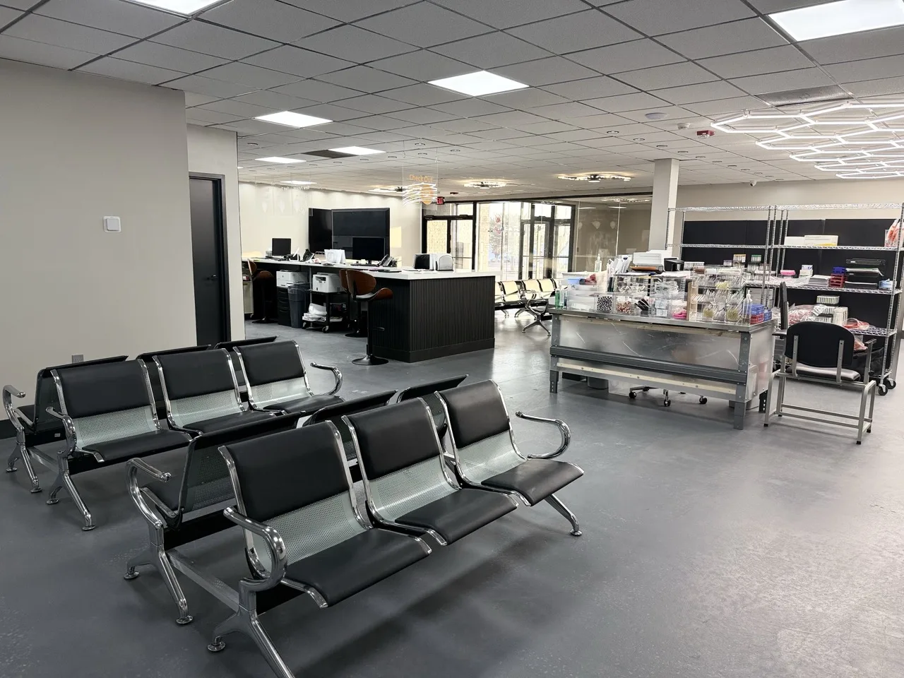Patient waiting room with seating and clinical carts near the reception desk at the Padda Institute Bridgeton office, 12174 Natural Bridge Road, Bridgeton, MO 63044