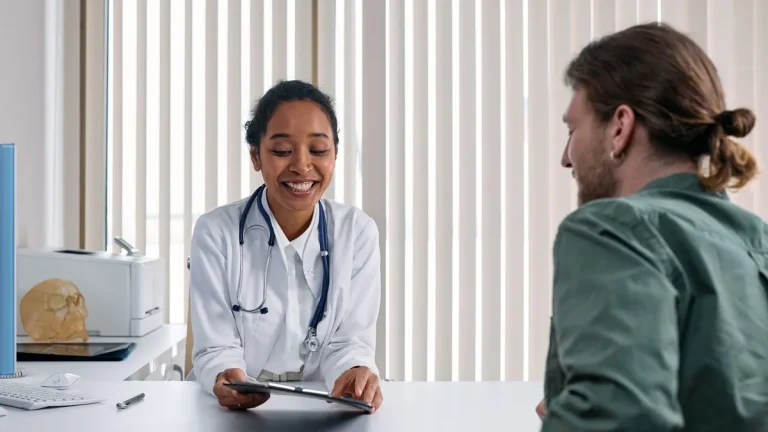 A doctor and patient engaging in a positive consultation in a bright clinic setting.