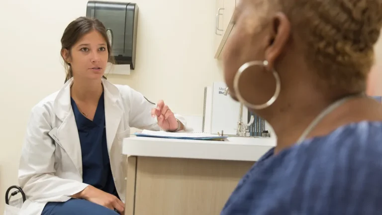 Doctor in consultation with patient at a medical clinic, discussing treatment options.