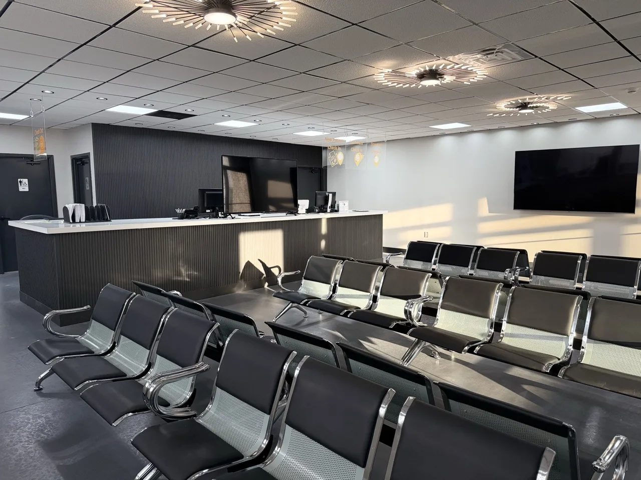 Patient waiting room with rows of seating facing the reception desk, at Padda Institute, 4477 Woodson Road, St. Louis, MO 63134