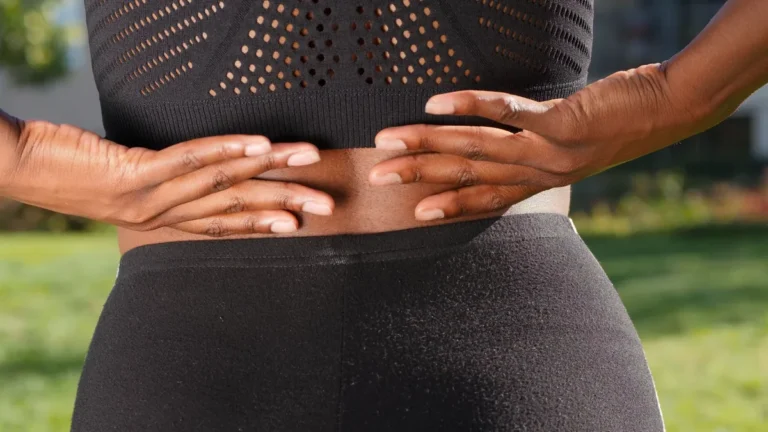 Hands pressed against the lower back over the lumbar discs a discogram tests