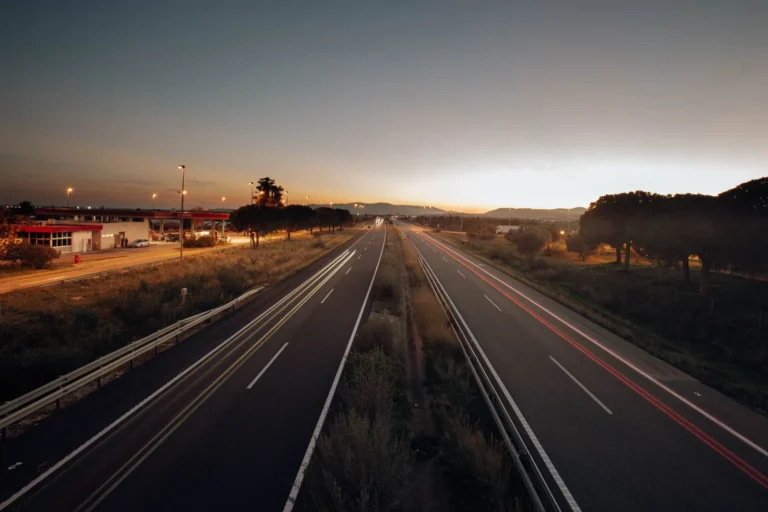 Expressway at dawn with long-exposure headlight trails