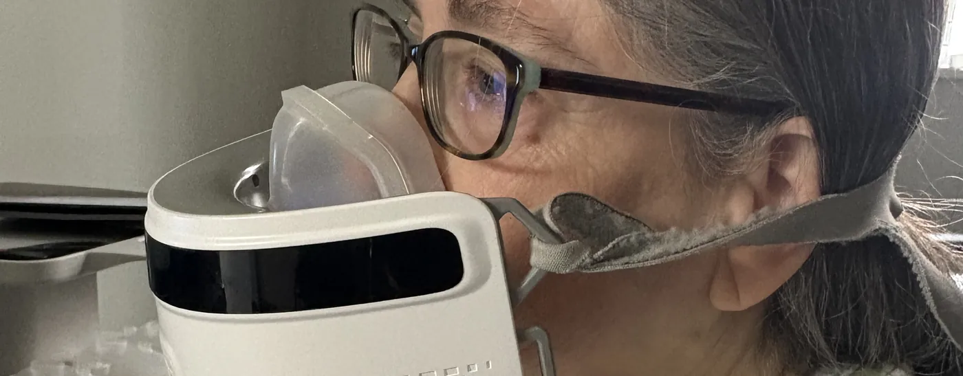 Patient breathing through a mask during respiratory quotient (RQ) metabolic testing at Padda Institute, St. Louis