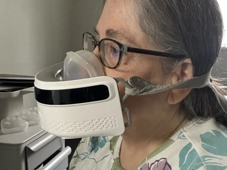 Patient breathing through a mask during respiratory quotient (RQ) metabolic testing at Padda Institute, St. Louis