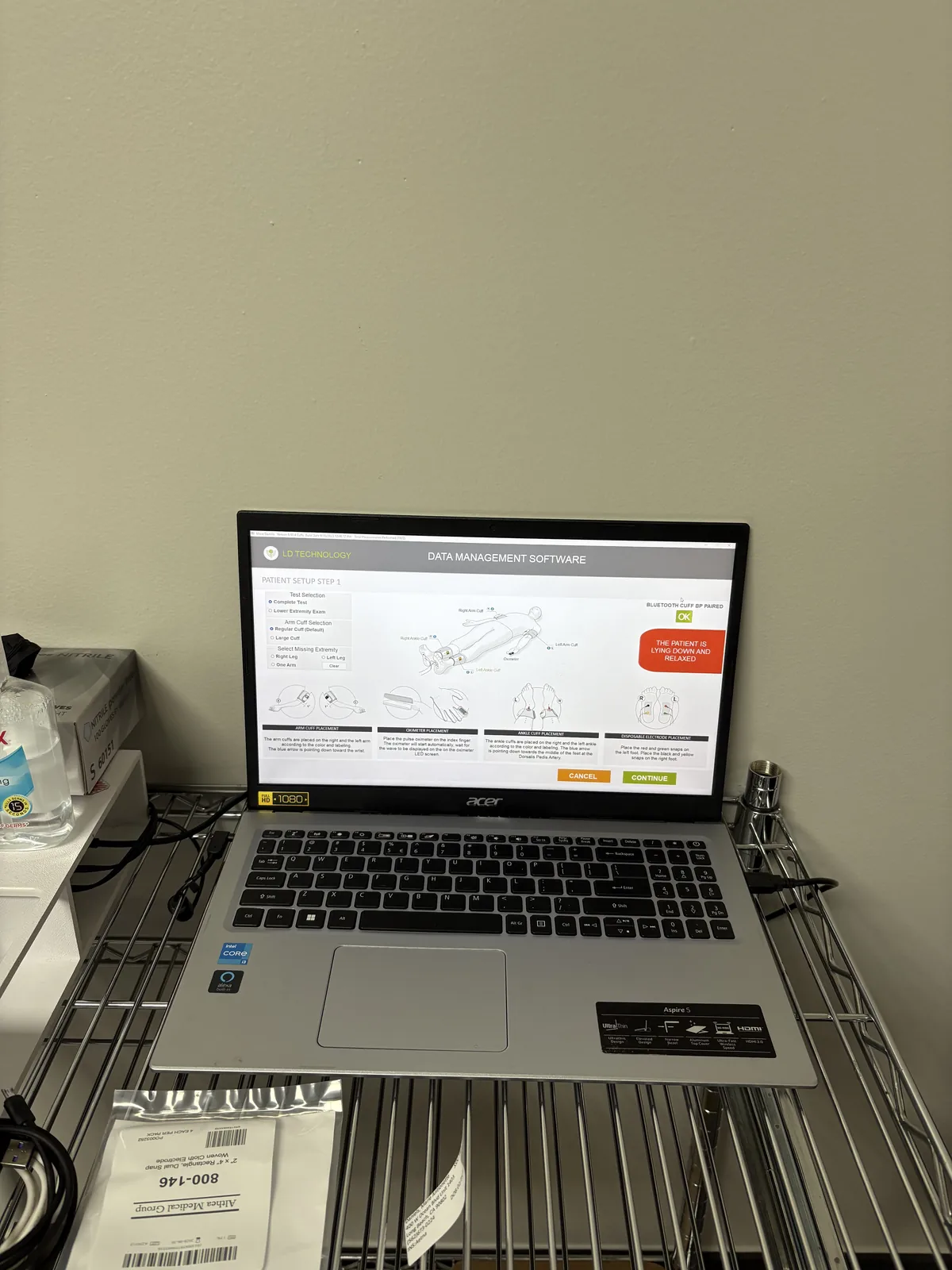 Testing laptop running the SMAT data management software beside the exam table at Padda Institute, St. Louis